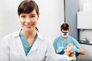 Dental Hygienist Cleaning Dental Patient's Mouth