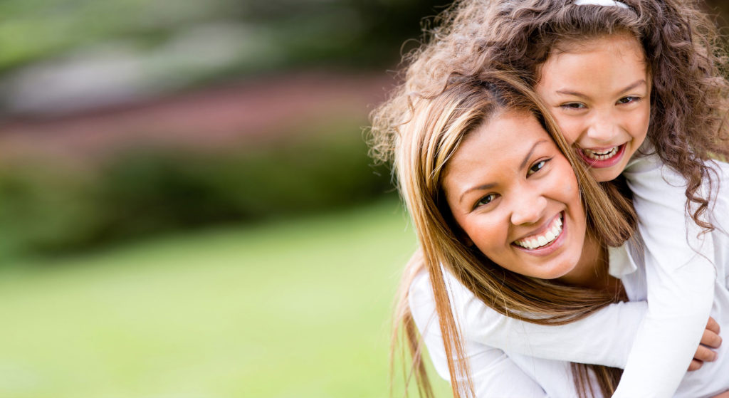 mother and daughter smiling after dental procedure