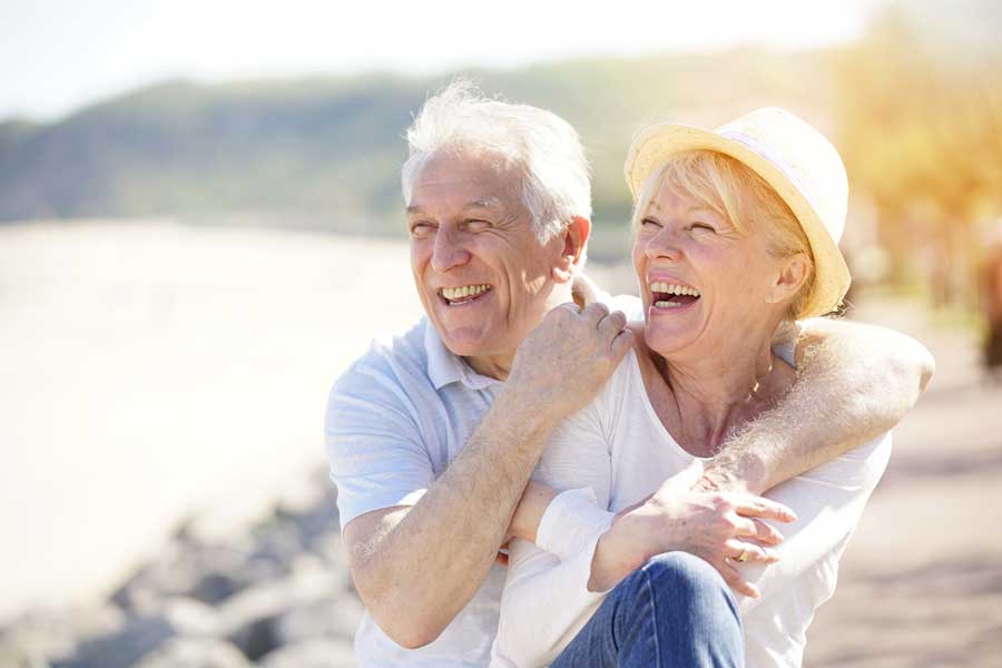 elderly couple smiling with their all on 4 dental implants