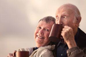 Two Dental Implant Patients Smiling Together While Drinking Coffee