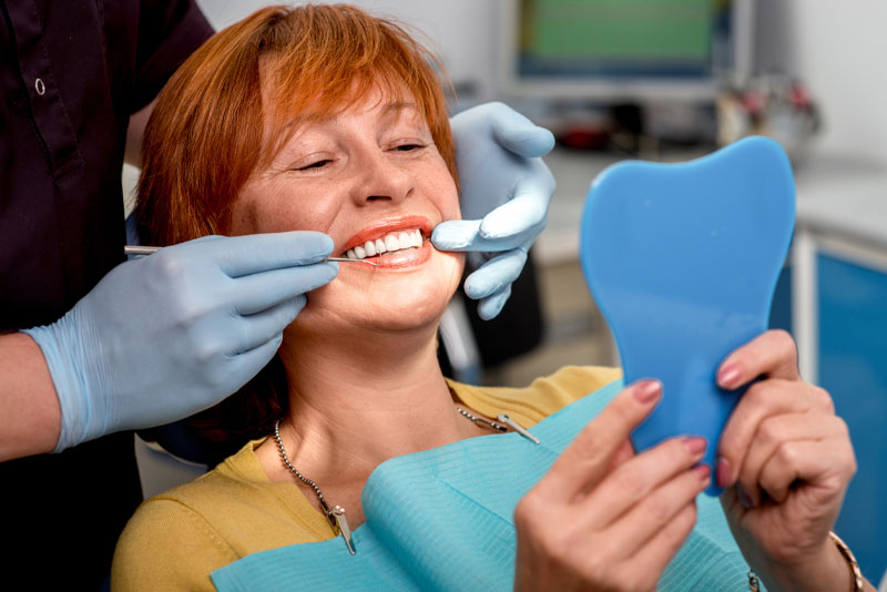 Dental Patient Smiling While Getting A Full Arch Dental Implant Procedure